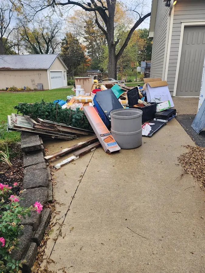 Dumpster being loaded with debris for Commercial Dumpster Rental in Ontwa